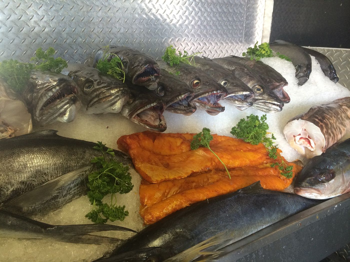 Fresh and smoked fish laid out on ice at a Hout Bay fish counter.